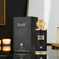 Mashrabya Lattafa edp perfume black gold packaging table candle lights closeup