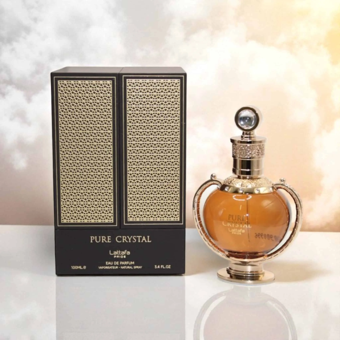 Lattafa Pride Pure Crystal edp in elegant packaging on white surface against cloudy background closeup view