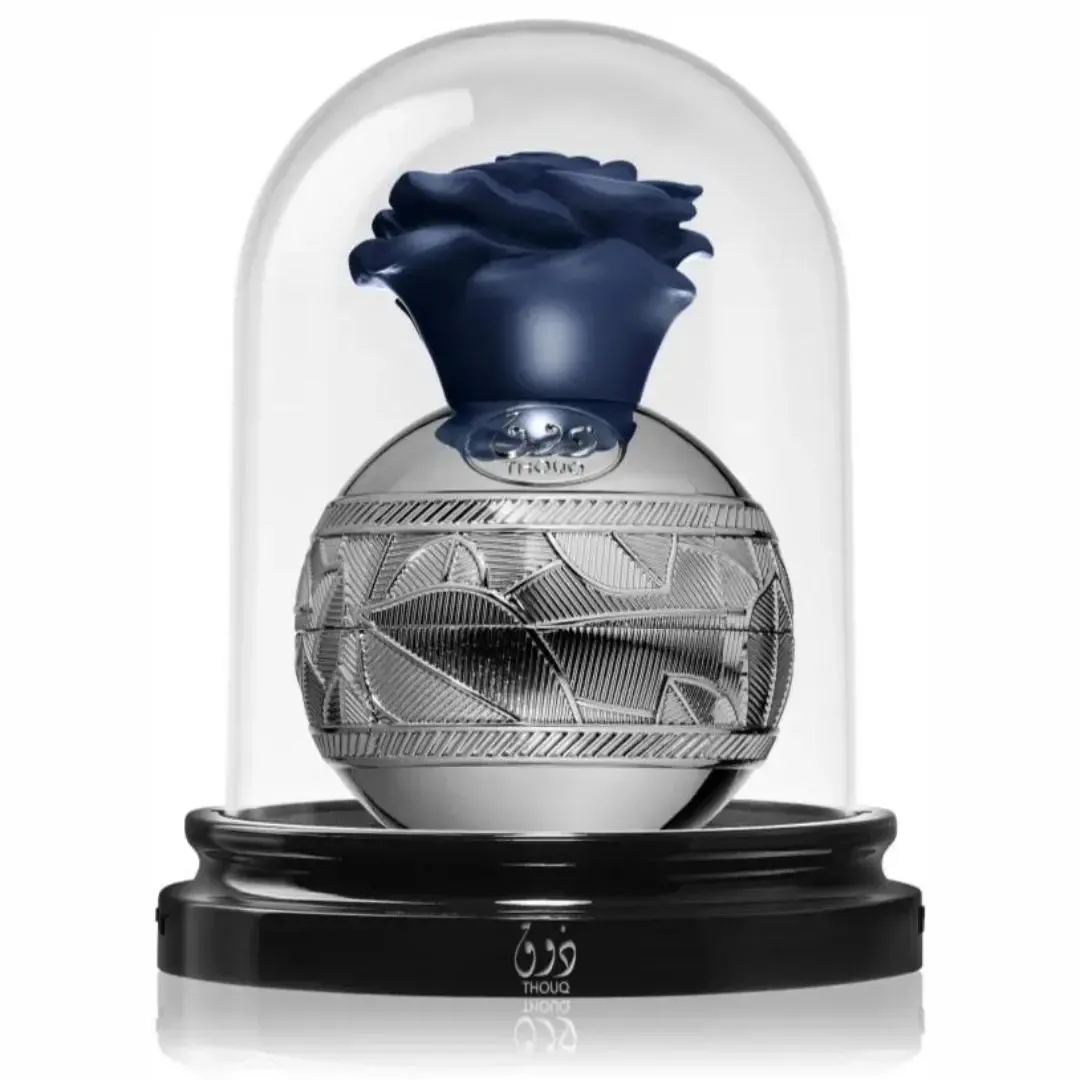 Lattafa Pride thouq edp silver metal flask in glass dome base black round stand closeup