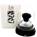 Lattafa Pride Thouq edp perfume bottle in glass case with black rose on white background packaging box beside it