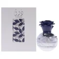Lattafa Pride Thouq edp perfume bottle in a decorative glass container next to grey packaging background white surface