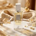 Lattafa Ana Abiyedh Leather 60ml — White perfume box and glass bottle with gold accents and Arabic calligraphy, showing the product packaging and bottle design. | Kotak minyak wangi putih dan botol kaca dengan aksen emas dan kaligrafi Arab, menunjukkan pembungkusan produk dan reka bentuk botol.