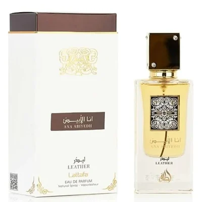 Lattafa Ana Abiyedh Leather 60ml — White perfume box and glass bottle with gold accents and Arabic calligraphy, showing the product packaging and bottle design. | Kotak minyak wangi putih dan botol kaca dengan aksen emas dan kaligrafi Arab, menunjukkan pembungkusan produk dan reka bentuk botol.