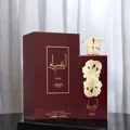 Ansaam Gold Lattafa Pride edp perfume bottle on black table beside packaging box closeup