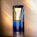 Al Nashama Caprice Lattafa blue glass edp on table surface closeup view