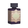 Lattafa Bade'e Al Oud Amethyst Fusion 100ml — A purple perfume bottle with a dark grey cap and a gold and light green geometric label. | Lattafa Bade'e Al Oud Amethyst Fusion 100ml — Botol minyak wangi ungu dengan penutup kelabu gelap dan label geometri emas dan hijau muda.