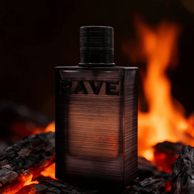 Nuit Parfaite Rave edp perfume bottle on burning wood pile at night closeup