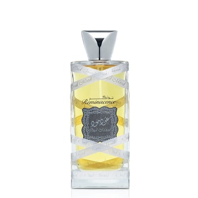 Lattafa Oud Mood Reminiscence 100ml — A cylindrical grey box with silver ornate patterns and a silver ribbon handle stands next to a clear glass perfume bottle with a silver cap, wrapped in white ribbon. | Lattafa Oud Mood Reminiscence 100ml — Kotak kelabu silinder dengan corak perak berhias dan pemegang reben perak