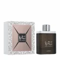 Oud Najdia Lattafa perfume next to wrapper white light brown dark minimalist
