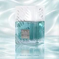 Lattafa Khamrah Waha Lattafa Perfumes 100ml EDP — A clear glass perfume bottle with a textured cap sits next to its blue