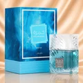 Lattafa Khamrah Waha Lattafa Perfumes 100ml EDP — A clear glass perfume bottle with a textured cap sits next to its blue