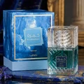 Lattafa Khamrah Waha Lattafa Perfumes 100ml EDP — A clear glass perfume bottle with a textured cap sits next to its blue