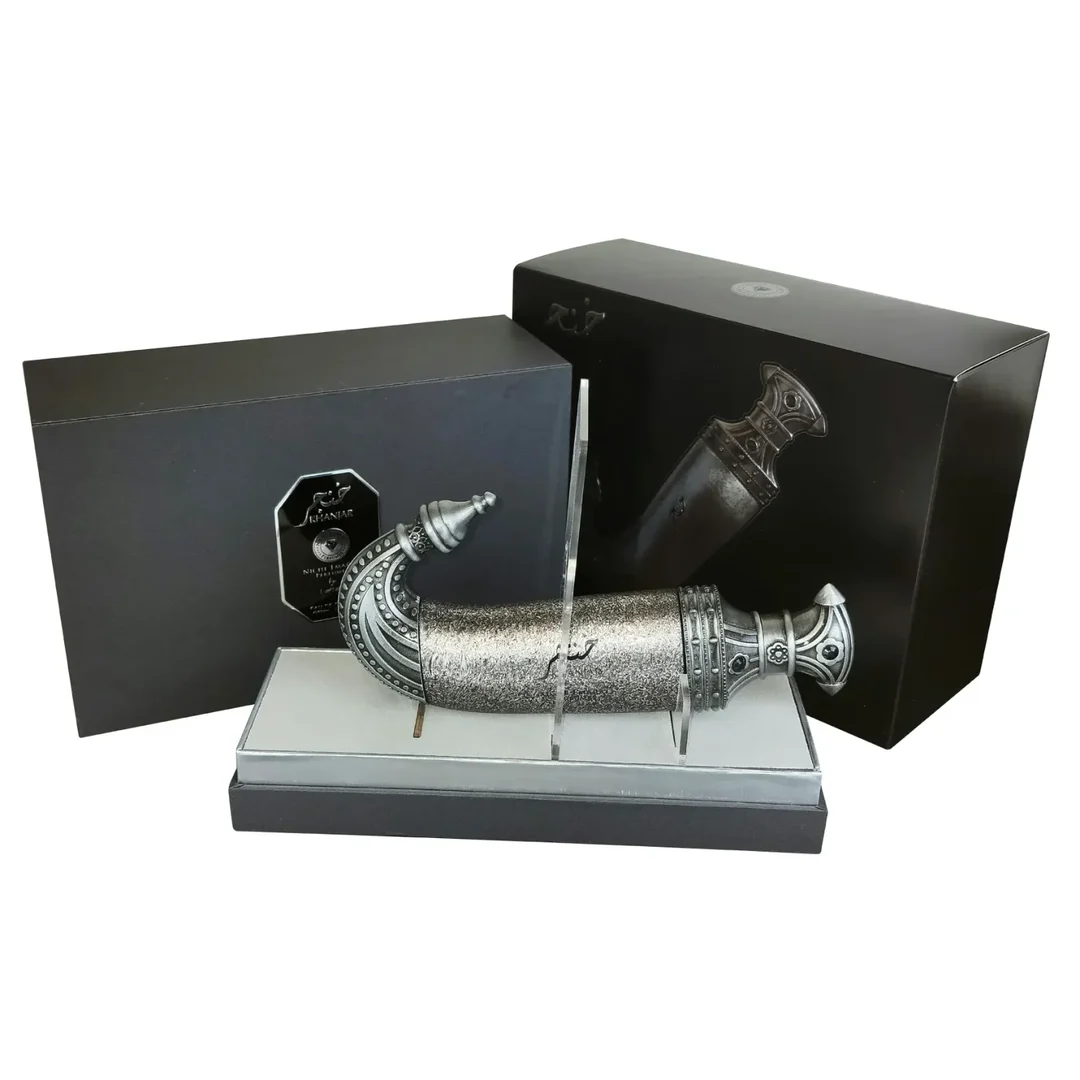Niche Emarati Khanjar by Niche Emarati 85ml EDP — Black box with silver label and ornate dagger-shaped perfume bottle