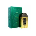 Lattafa Pride Maharjan Gold — A gold perfume bottle with a black mosaic cap and decorative panel sits next to its matching dark green embossed box. | Lattafa Pride Maharjan Gold — Botol minyak wangi emas dengan penutup mozek hitam dan panel hiasan duduk di sebelah kotak hijau gelapnya yang bertebuk.