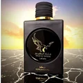Lattafa Malik Al Tayoor Concentrated 100ml — Black perfume bottle with gold cap and eagle emblem, next to its black and gold patterned box with matching emblem. | Lattafa Malik Al Tayoor Concentrated 100ml — Botol minyak wangi hitam dengan penutup emas dan lambang helang, bersebelahan kotak corak hitam dan emasnya