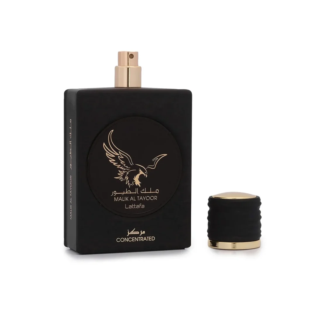 Lattafa Malik Al Tayoor Concentrated 100ml — Black perfume bottle with gold cap and eagle emblem, next to its black and gold patterned box with matching emblem. | Lattafa Malik Al Tayoor Concentrated 100ml — Botol minyak wangi hitam dengan penutup emas dan lambang helang, bersebelahan kotak corak hitam dan emasnya