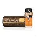 Lattafa Musamam Eau De Parfum 100ml by Lattafa — A golden snake coils around a clear glass perfume bottle filled with amber liquid, next to a textured brown cylindrical case with a snake-skin pattern. | Lattafa Musamam Eau De Parfum 100ml by Lattafa — Ular emas melilit botol minyak wangi kaca jernih berisi cecair