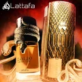 Lattafa Musamam Eau De Parfum 100ml by Lattafa — A golden snake coils around a clear glass perfume bottle filled with amber liquid, next to a textured brown cylindrical case with a snake-skin pattern. | Lattafa Musamam Eau De Parfum 100ml by Lattafa — Ular emas melilit botol minyak wangi kaca jernih berisi cecair
