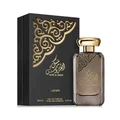 Lattafa Musk Al Aroos — A dark blue perfume bottle with gold Arabic calligraphy and 'MUSK AL AROOS LATTAFA' text, presented in an open dark blue gift box with a black velvet insert. | Lattafa Musk Al Aroos — Botol minyak wangi biru gelap dengan kaligrafi Arab emas dan teks 'MUSK AL AROOS LATTAFA', dipersembahkan dalam