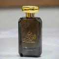 Lattafa Musk Al Aroos — A dark blue perfume bottle with gold Arabic calligraphy and 'MUSK AL AROOS LATTAFA' text, presented in an open dark blue gift box with a black velvet insert. | Lattafa Musk Al Aroos — Botol minyak wangi biru gelap dengan kaligrafi Arab emas dan teks 'MUSK AL AROOS LATTAFA', dipersembahkan dalam