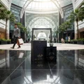 Shaghaf Man Asdaaf Lattafa stylish black packaging marble floor mall setting low angle view