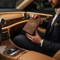 Man holding Afaq Gold Lattafa edp brown wooden packaging inside car