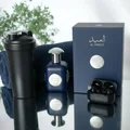 Al Ameed Lattafa edp fragrance blue glass beside black items reflective surface