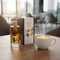 Ameer Al Oudh Intense Lattafa edp on wooden table next steam coffee cup side