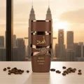 Asad Bourbon Lattafa brown fragrance on table coffee beans city view sunset golden