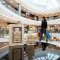 Badee Al Oud Honor Glory Lattafa white bottles black table mall background shopping