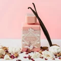 Badee Al Oud Noble Blush Lattafa pink perfume bottle surrounded vanilla beans dried roses