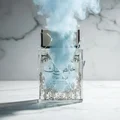 Pure Musk Lattafa edp on cracked glass marble surface surrounded smoke cloud overhead