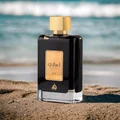 Ejaazi Lattafa black rectangular glass cologne men gold cap beach sand ocean