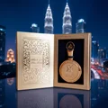 Fakhar Extrait Lattafa gold packaging table kuala lumpur city skyline