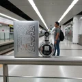 Fakhar Platin Lattafa silver fragrance on railing subway station platform closeup