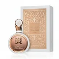 Fakhar Rose Gold Lattafa perfume bottle next beige packaging white background side view