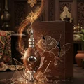Hala Lattafa perfume bottle in wooden case exploding glass shards smoke rising
