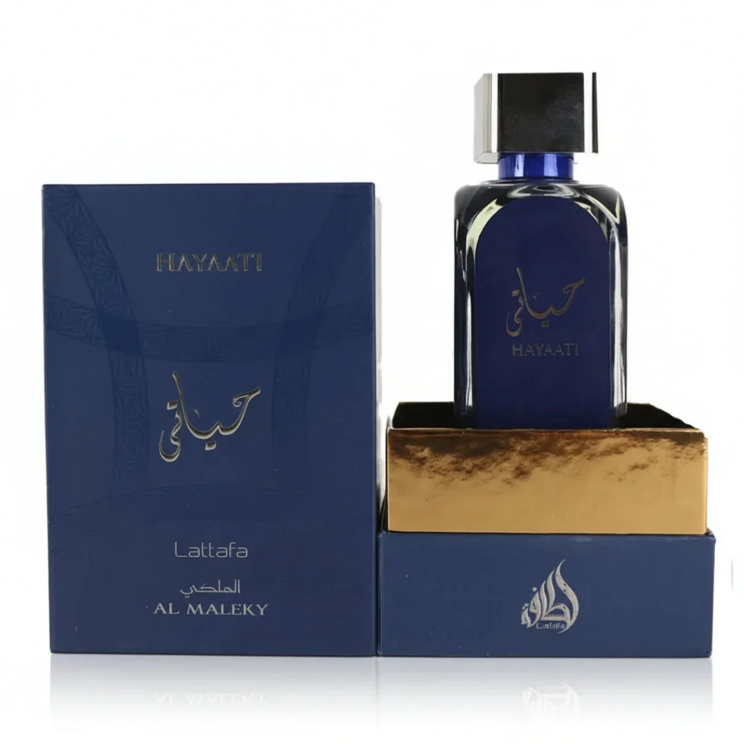 Hayaati Al Maleky Lattafa dark blue glass fragrance bottle on gold stand next navy