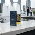 Jasoor Lattafa perfume on marble ledge city fountain background gold design blue box