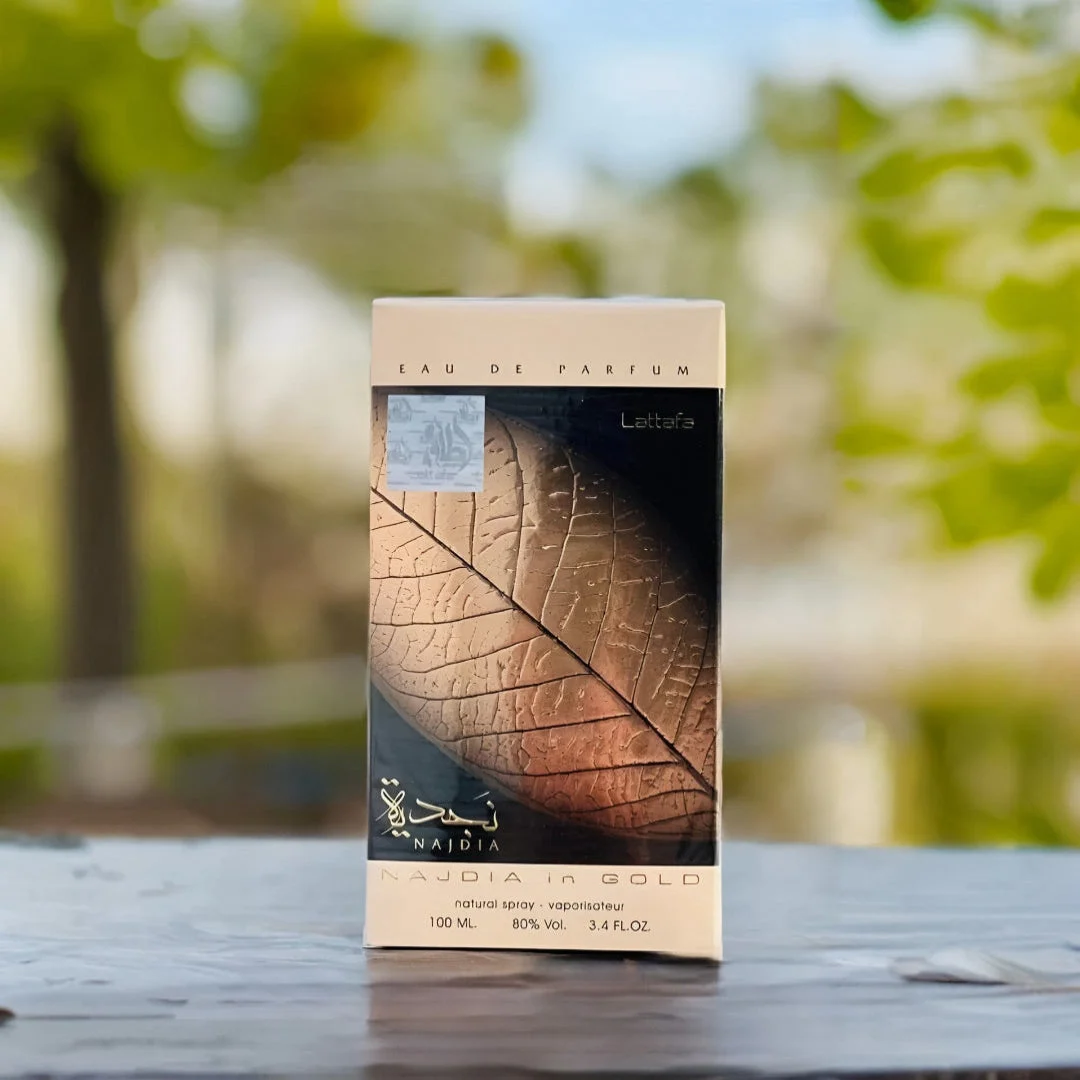 Najdia in Gold Lattafa unisex edp packaging wooden table outdoors Malaysia closeup