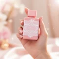 Badee Al Oud Noble Blush Lattafa pink perfume bottle in hand closeup view