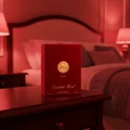 Opulent Red Lattafa perfume packaging bedside table bedroom setting softly lit