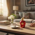 Opulent Red Lattafa fragrance on table cup coffee flowers books relaxed atmosphere home