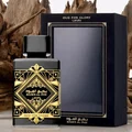 Badee Al Oud for Glory Lattafa black gold fragrance white surface wooden pieces