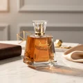 Bottle of Lattafa Raghba Eau De Parfum on marble table next to brown book beige cloth