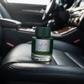 Qaaed Intense Lattafa perfume green glass car seat closeup view from side front