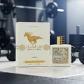 Qaed Al Fursan Unlimited Lattafa edp perfume on gym floor next to white box water drops