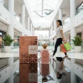 Shahd Lattafa perfume on table shopping mall interior background woman carrying bags nearby