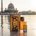 Lattafa simply oud edp bottles on a marble surface near water body malaysia mosque background