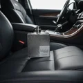 Suqraat Lattafa edp men silver cologne on car seat interior view closeup side shot